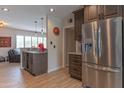 Well-lit kitchen featuring stainless steel refrigerator, custom cabinets, and granite countertops at 6702 E Monte Vista Rd, Scottsdale, AZ 85257