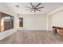 Bright, open living room with tile floors, a ceiling fan, and plentiful natural light at 6915 S Sapphire Way, Chandler, AZ 85249