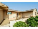 Inviting home entrance with decorative security door and tidy desert landscaping at 9634 W Glen Oaks N Cir, Sun City, AZ 85351