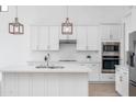 Bright kitchen featuring a quartz countertop island, stainless appliances, and subway tile backsplash at 9850 E Mcdowell Mountain Ranch Rd # 1006, Scottsdale, AZ 85260