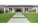 A backyard with covered patio, solar panels, artificial grass, and concrete pavers at 1265 E La Fortuna Ct, San Tan Valley, AZ 85140