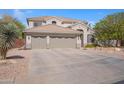 Attractive residence showcasing a three-car garage and desert-friendly landscaping at 1554 E Stirrup Ct, Gilbert, AZ 85296