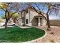 Two-story home with a two-car garage, neutral paint scheme, lawn, and mature trees at 1635 W Dunbar Dr, Phoenix, AZ 85041