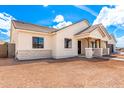 Low angle view of a stucco home with desert landscaping, a covered entry, stone accents, and a tile roof at 1645 E Minton St, Mesa, AZ 85203