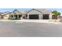 Beautiful single-story home with a neutral color scheme and a spacious three-car garage at 1645 E Minton St, Mesa, AZ 85203