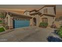 Exterior shot of the home with a well-manicured lawn, and a two-car garage at 16532 W Rowel Rd, Surprise, AZ 85387