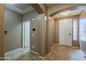 Inviting foyer featuring neutral tile flooring and an arched entryway at 16830 W Magnolia St, Goodyear, AZ 85338