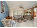 Comfortable living room featuring neutral color scheme and an open layout to the kitchen at 19140 N Tamarisk Flower Way, Surprise, AZ 85387