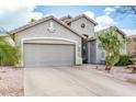 A single-Gathering home featuring desert landscaping and a two-car garage at 212 E Canary Ct, San Tan Valley, AZ 85143