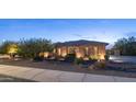 Beautiful exterior of a stone-clad home with desert landscaping, enhanced by charming outdoor lighting for evening appeal at 2224 N 83Rd Cir, Mesa, AZ 85207