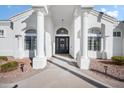Covered front entry featuring double pillars, an arched window, and a black front door at 2251 N 32Nd St # 10, Mesa, AZ 85213