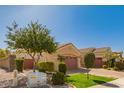 Tan single story home with desert landscaping, shade tree and a 2 car garage at 2263 E Jade Ct, Chandler, AZ 85286