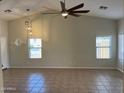 Bright living room with tiled floors, high ceilings, and modern lighting at 24638 N 65Th Ave, Glendale, AZ 85310