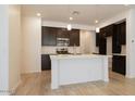 Modern kitchen featuring dark wood cabinetry and white quartz countertops at 2663 S Equestrian Dr # 106, Gilbert, AZ 85295
