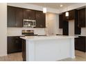 Well-lit kitchen with stainless steel appliances, quartz countertops, and an island at 2663 S Equestrian Dr # 106, Gilbert, AZ 85295