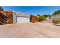 Attractive single-story home featuring desert landscaping, a gray exterior, and a two-car garage at 340 E Harwell Rd, Gilbert, AZ 85234