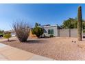 Attractive single-story home showcasing desert landscaping, a large saguaro cactus, and solar panels at 340 E Harwell Rd, Gilbert, AZ 85234
