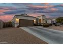 Lovely single-story home featuring a two-car garage, neutral stucco, and long driveway at 36070 N Quiros Dr, San Tan Valley, AZ 85143