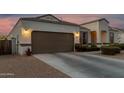 Lovely two-car garage with beautiful stucco, exterior lighting, and well-maintained driveway at 36070 N Quiros Dr, San Tan Valley, AZ 85143