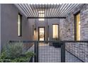 Welcoming entrance featuring a metal pergola, stone accents, and a glimpse of the home's interior at 37200 N Cave Creek Rd # 1035, Scottsdale, AZ 85262