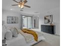 Bright main bedroom with light-colored walls, carpet, a sliding glass door and a view to the back yard at 3777 E Latham Ct, Gilbert, AZ 85297