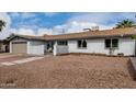 Lovely single-level home featuring a desert rock front yard and neutral exterior paint at 3832 W Eva St, Phoenix, AZ 85051