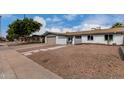 Beautiful single-story home with desert landscaping, walkway and attached garage at 3832 W Eva St, Phoenix, AZ 85051