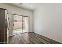 Bright open concept living room with wood floors and sliding door to backyard at 3894 E Palmer St, Gilbert, AZ 85298
