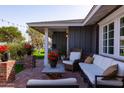 Relaxing outdoor patio with comfortable seating, brick columns, and ambient string lights at 4639 E Mulberry Dr, Phoenix, AZ 85018