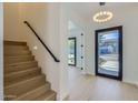 Bright entryway with hardwood floors, staircase, modern lighting, and views to the exterior at 4640 E Glenrosa Ave, Phoenix, AZ 85018