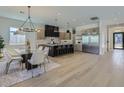 Expansive kitchen open to the dining room featuring stainless appliances, a large island, and sleek cabinetry at 4640 E Glenrosa Ave, Phoenix, AZ 85018