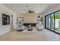 Bright and airy living room with a fireplace, floating shelves, and hardwood floors at 4640 E Glenrosa Ave, Phoenix, AZ 85018
