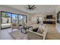 Open-concept living space with hardwood floors, modern furniture, and large sliding glass doors to outside at 4640 E Glenrosa Ave, Phoenix, AZ 85018