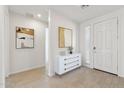 Bright foyer with wood-look tile flooring, white wainscoting, and contemporary art at 5046 W Karl St, San Tan Valley, AZ 85144