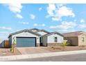 The home features a two-car garage, low-maintenance landscaping, and a brick driveway at 5046 W Karl St, San Tan Valley, AZ 85144