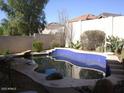 Backyard swimming pool with tile trim, rock features and privacy fence at 5050 E Roy Rogers Rd, Cave Creek, AZ 85331