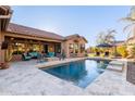 Inviting backyard pool area with a tiled patio, fire pit, and outdoor seating perfect for entertaining at 5215 S Monte Vista St, Chandler, AZ 85249