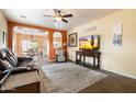 Comfortable living room with tile floors, a ceiling fan, and an open archway to the kitchen at 5622 E Emerald Cir, Mesa, AZ 85206