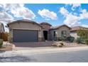 Inviting single-story home with a two-car garage and desert landscaping at 5723 E Jake Hvn, Cave Creek, AZ 85331
