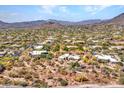 Desert home with a pool on a large private lot featuring a red outline and mountain views at 5805 E Agave Pl, Carefree, AZ 85377