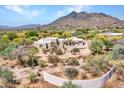 Desert home with a winding driveway and front yard landscaping at 5805 E Agave Pl, Carefree, AZ 85377