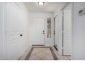 Bright entryway with white walls, tiled flooring, and a mirror by the front door at 6312 W Villa Linda Dr, Glendale, AZ 85310