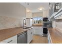 Bright kitchen with stainless steel appliances, tile backsplash, and white cabinetry at 7430 E Chaparral Rd # A239, Scottsdale, AZ 85250