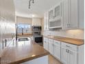 A bright kitchen featuring stainless steel appliances, light countertops, and white cabinetry at 7430 E Chaparral Rd # A239, Scottsdale, AZ 85250