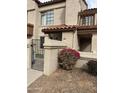Charming home featuring a gated front yard, a stucco facade, and a red tile roof at 839 S Westwood -- # 187, Mesa, AZ 85210