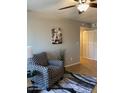 Comfortable living room featuring a patterned chair, modern rug, and stylish Eiffel Tower artwork, illuminated by a ceiling fan at 839 S Westwood -- # 187, Mesa, AZ 85210