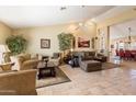 Spacious living room with high ceilings, tile flooring, and neutral paint tones at 8960 W Kerry Ln, Peoria, AZ 85382