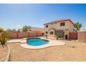 Backyard features a refreshing pool with well-maintained landscaping and a covered patio at 13321 N 124Th Ave, El Mirage, AZ 85335