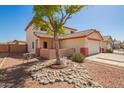 Beautiful front yard with desert landscaping, a shade tree, and stone accents at 13321 N 124Th Ave, El Mirage, AZ 85335