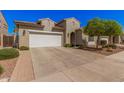 Home with a two-car garage and a well-maintained desert landscaping at 1446 E Canary Dr, Gilbert, AZ 85297